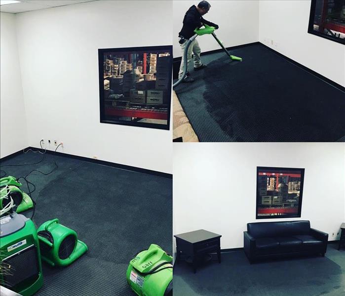 Technician extracting water from carpet in a warehouse office