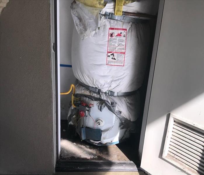 a water heater located inside a water heater closet.